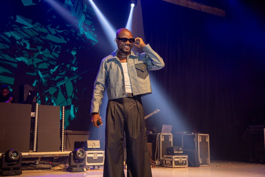 Artist performing under stage lights